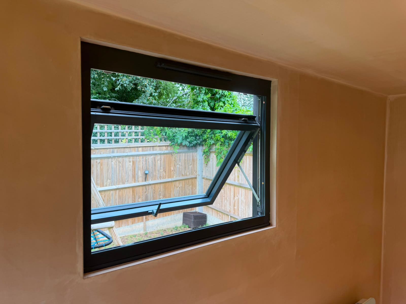 Top-hung desk window inside garden room