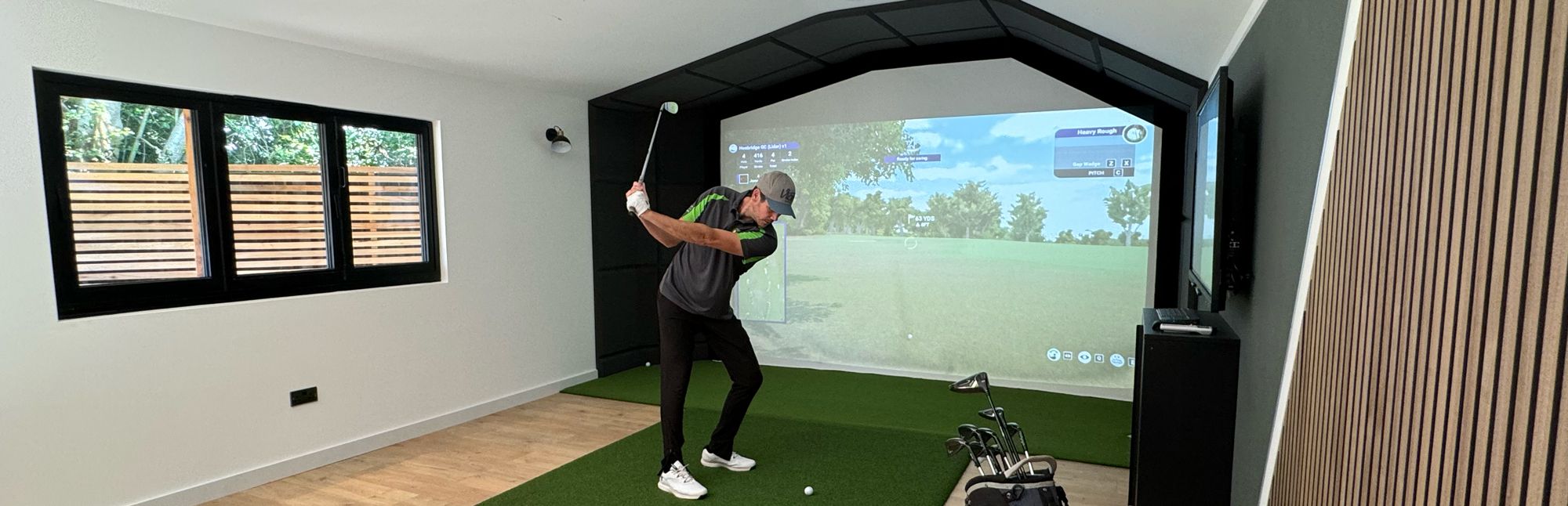 Golf simulator in action inside garden room