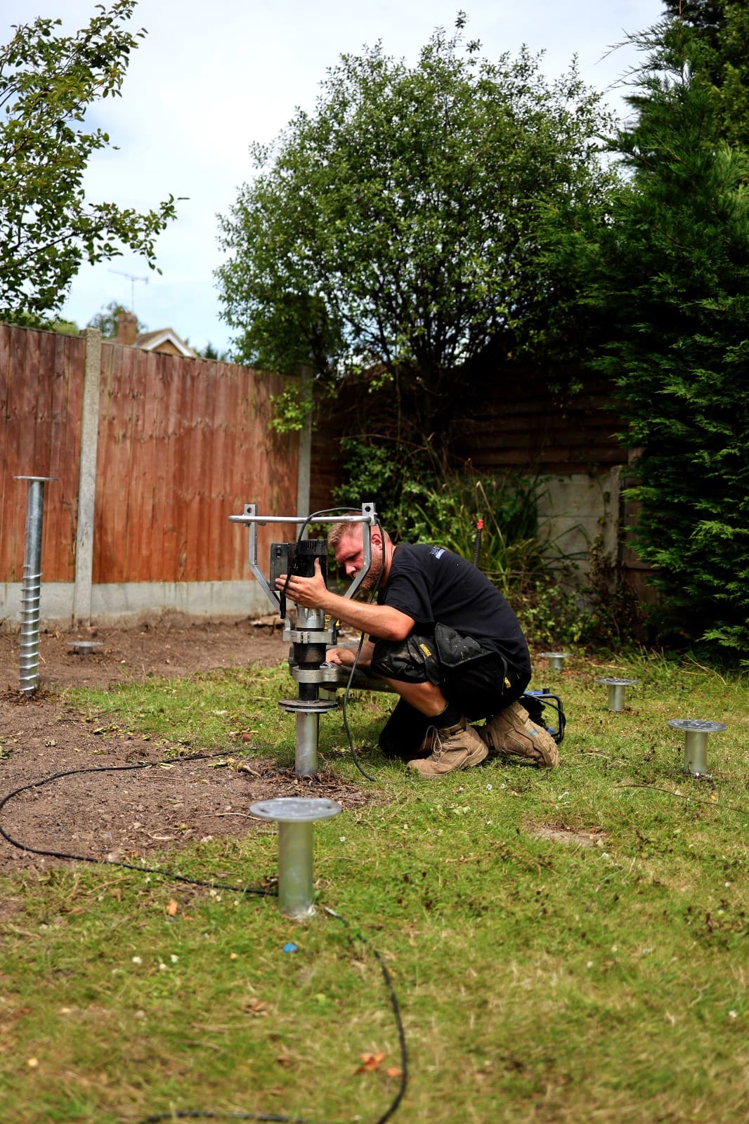 Ground screws being installed