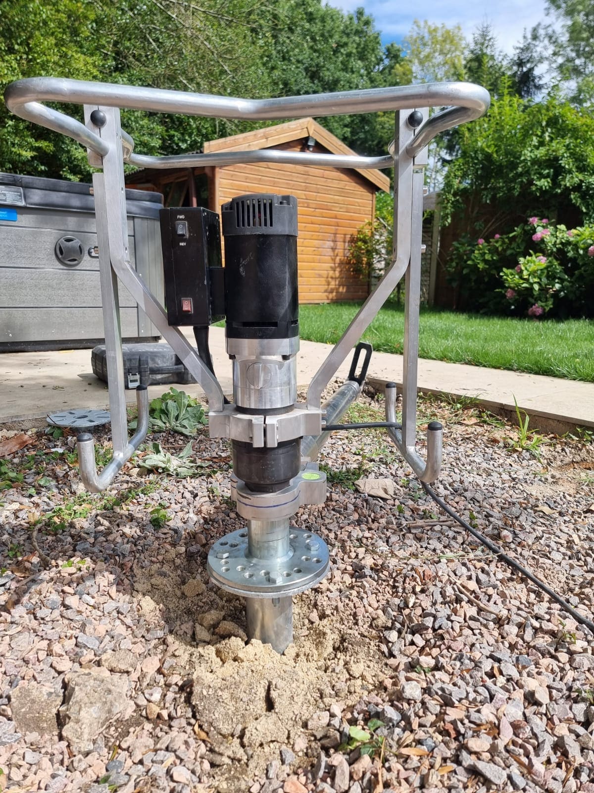 Ground screw installation machine on a garden room build in Surrey
