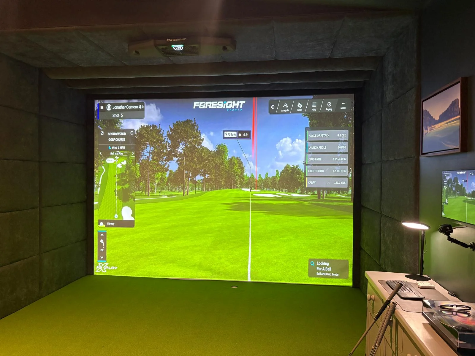 Golf simulator interior — playing position