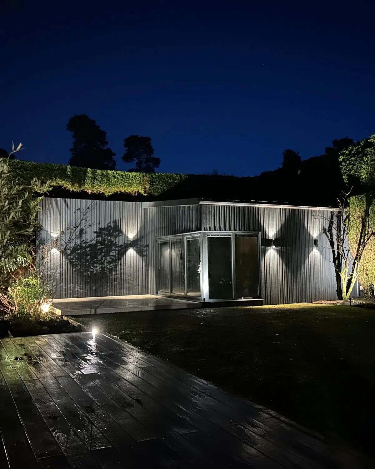 Golf simulator garden room at night with lighting