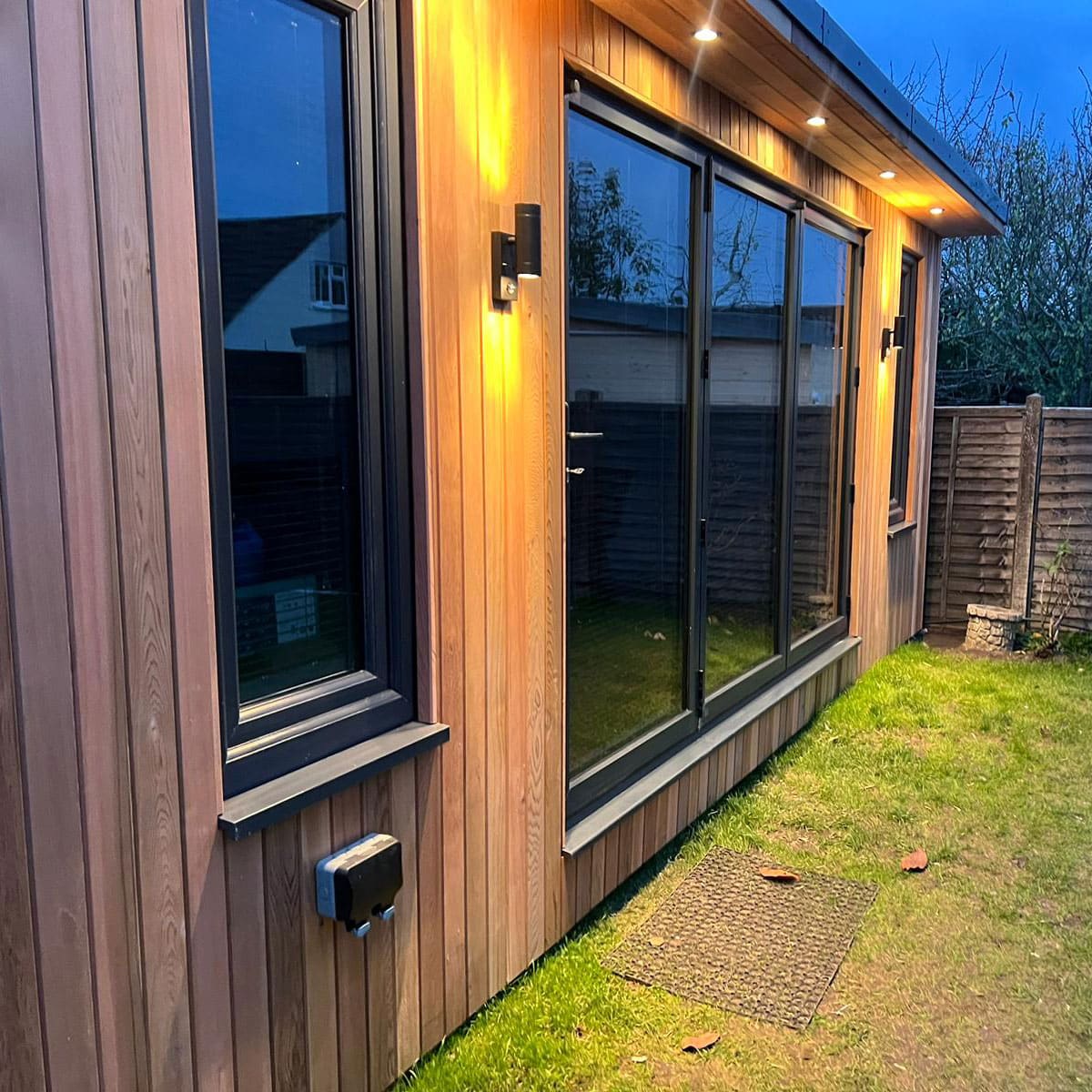 Garden room at night with LED canopy lighting