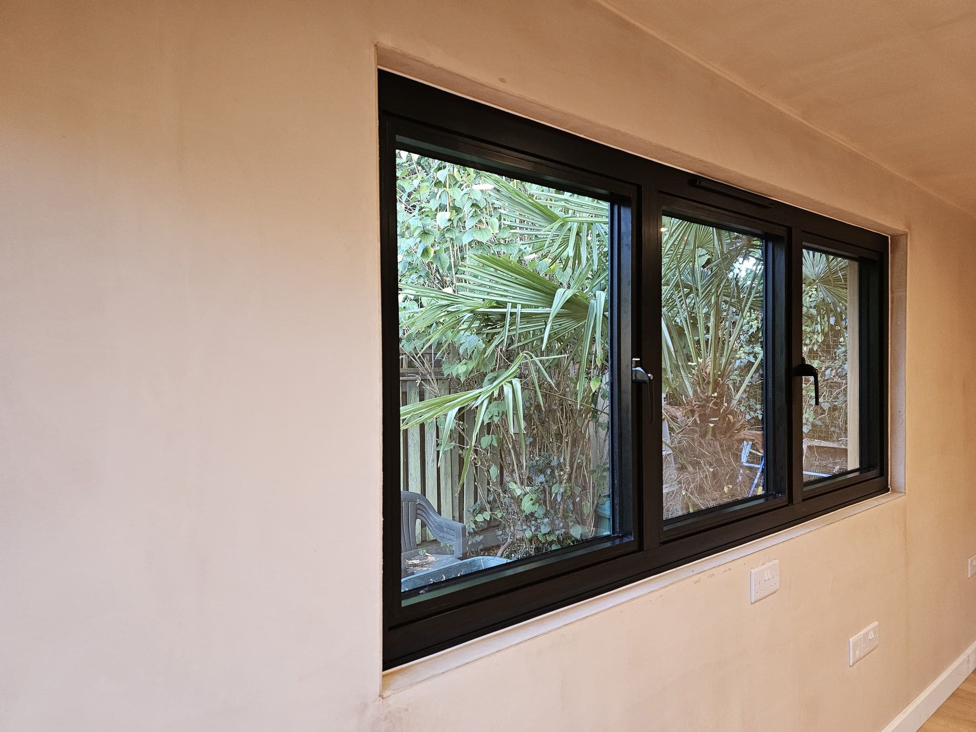 Triple aluminium window inside garden room